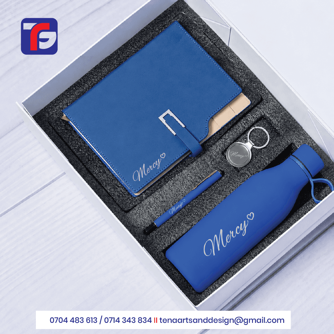 Blue personalised gift set with a notebook, bottle, pen and silver-toned keyring bearing the name Mercy in a white box.