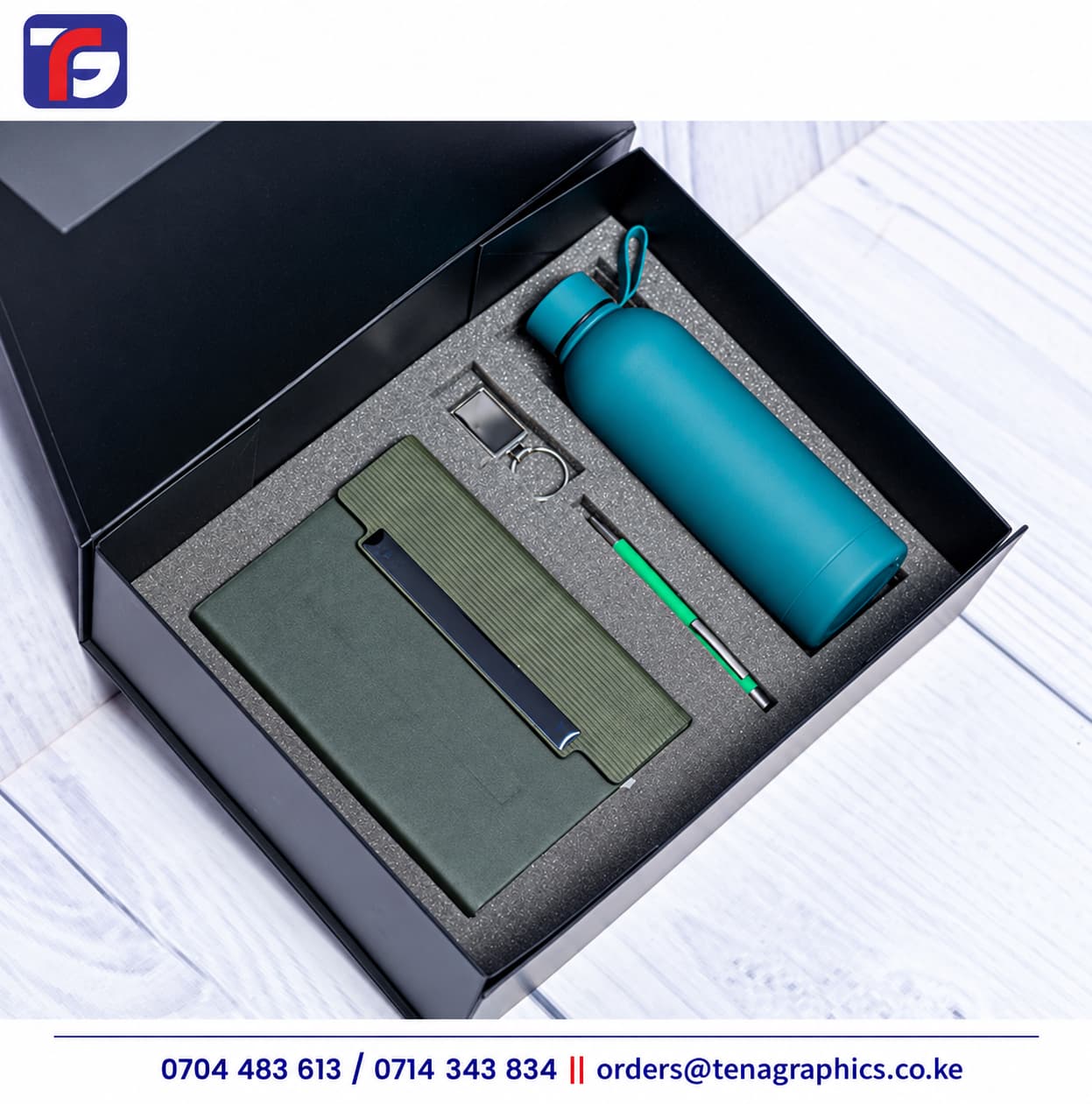 Green E128 end of year corporate gift set with olive notebook, teal bottle, green pen and metal keyholder