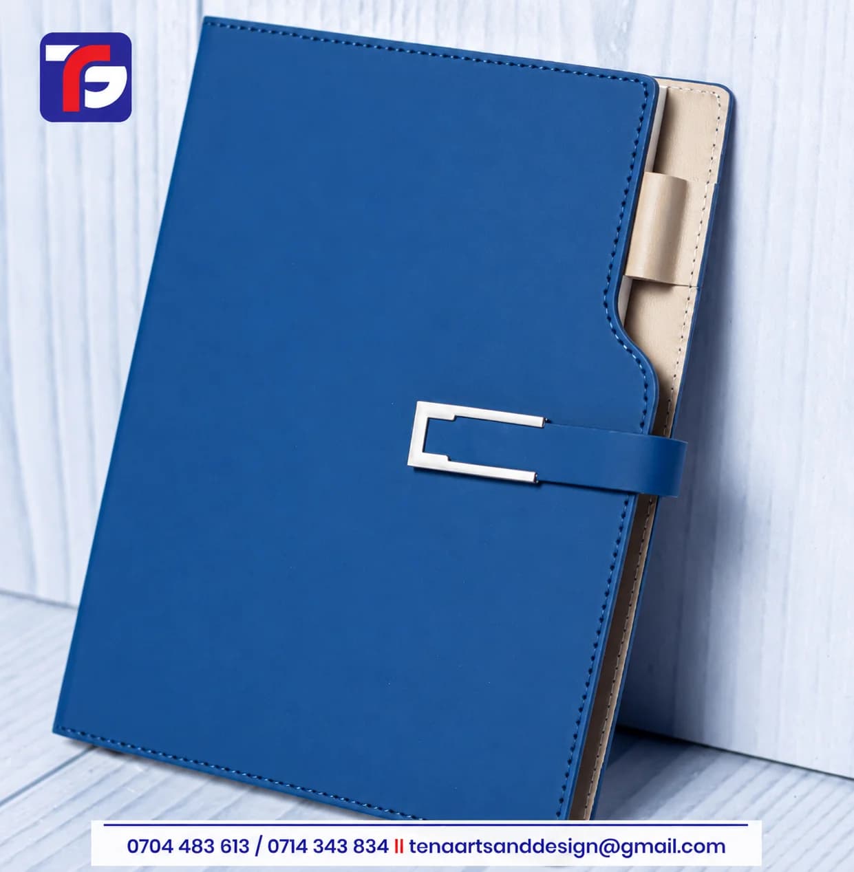 Dark blue A5 curved executive notebook with stitched edges, silver-tone strap detail and a contrasting inner panel with pen loop