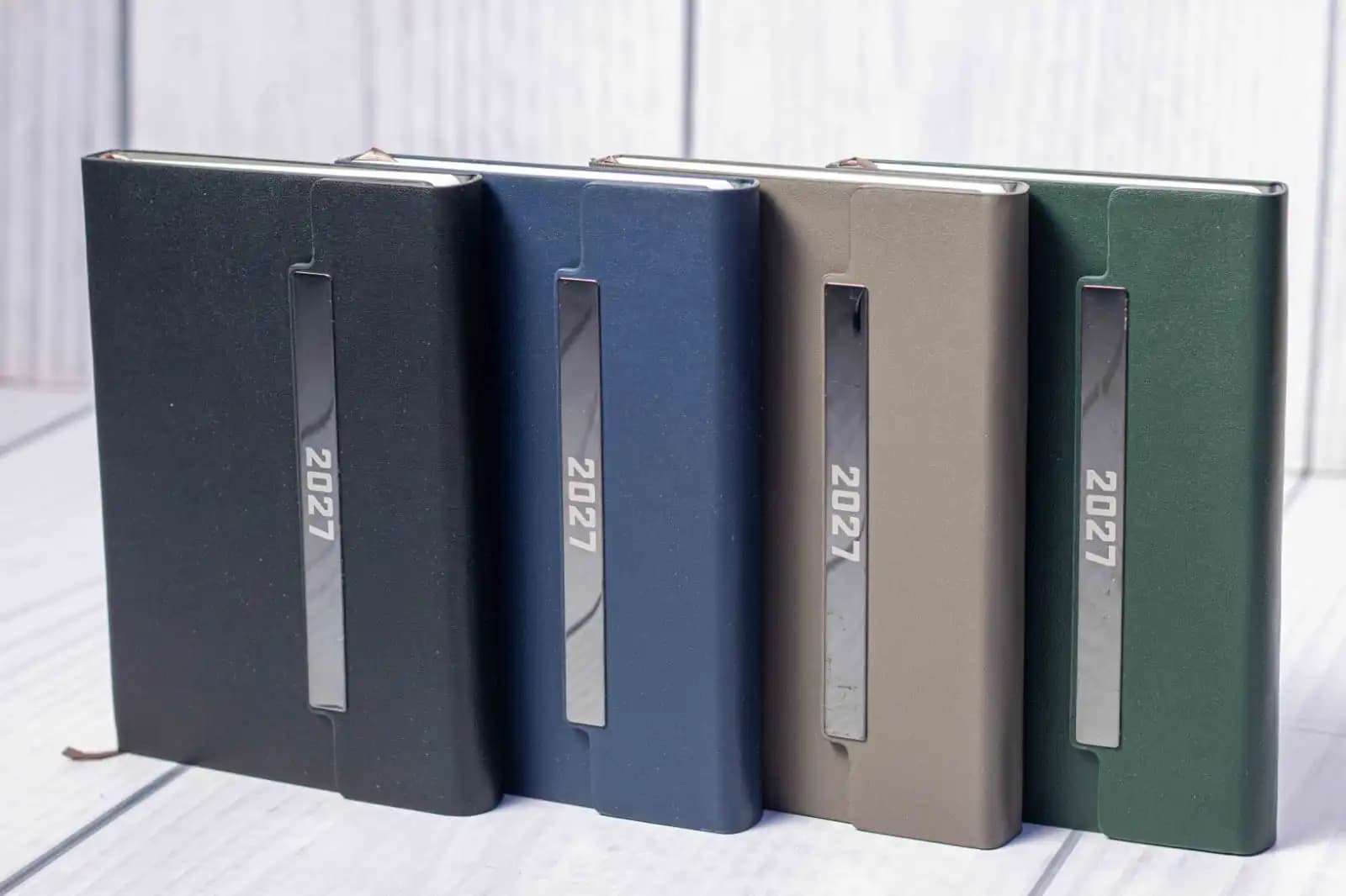 A5 T190 Executive Diary 2027 in black, navy blue, taupe grey and dark green with vertical metallic-style front accents