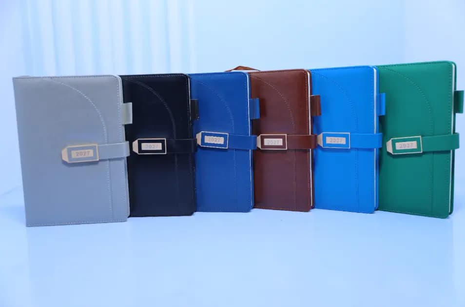 2027 A5 T201 executive diaries in grey, black, dark blue, brown, light blue and green with closure straps