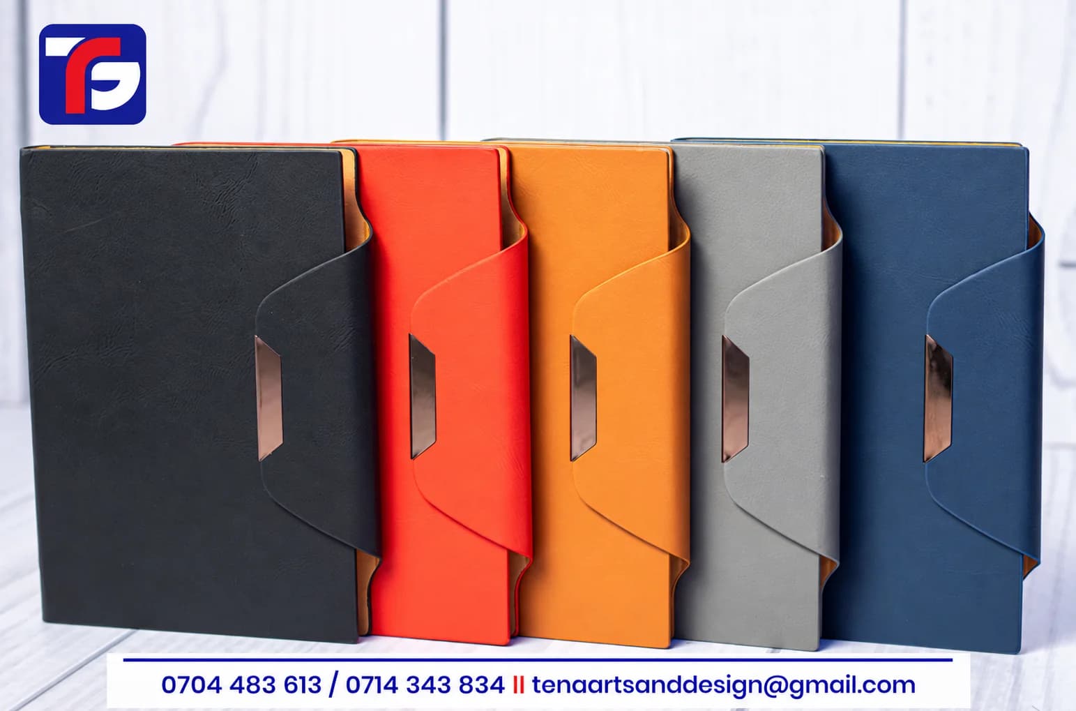B5 Goldstrap executive notebooks in black, red, brown, grey and blue with wraparound closure flaps and metallic accents