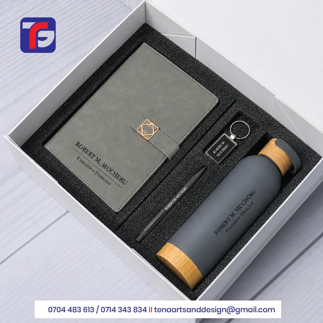 Grey personalised executive gift set with notebook, bottle, black pen and keyring branded for Robert M. Mucheru.