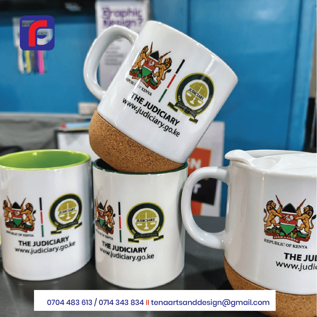 Branded cork base mug in white with Judiciary artwork, shown above other printed mugs, including a cork base mug with a white lid.
