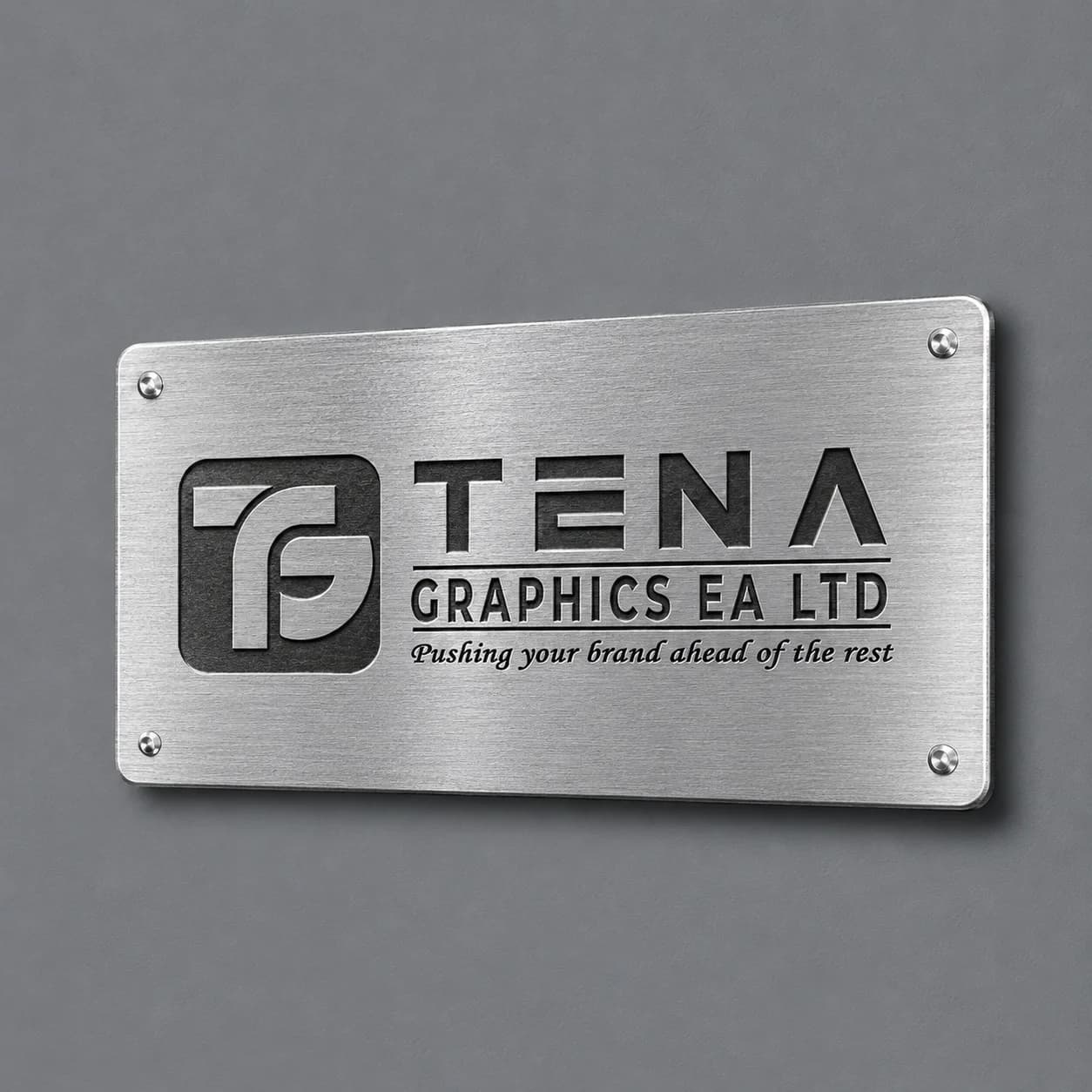 Engraved metal company nameplate with Tena Graphics logo, dark lettering and four corner fixings