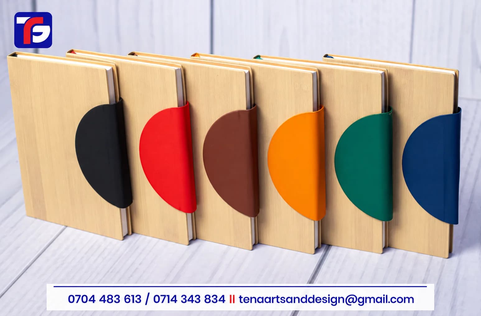 Executive Bamboo Notebook range with light grain-pattern covers and black, red, brown, orange, green and blue curved closure flaps
