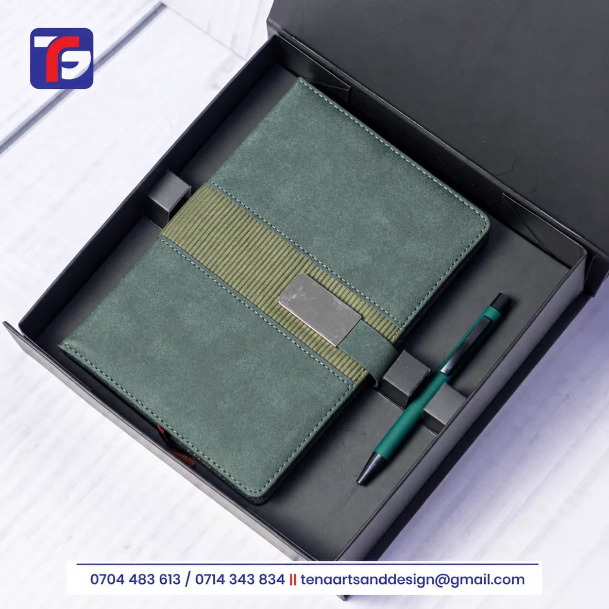 Green executive Silver Buckle notebook set with a ribbed band, silver-tone strap detail and matching pen in an open black box