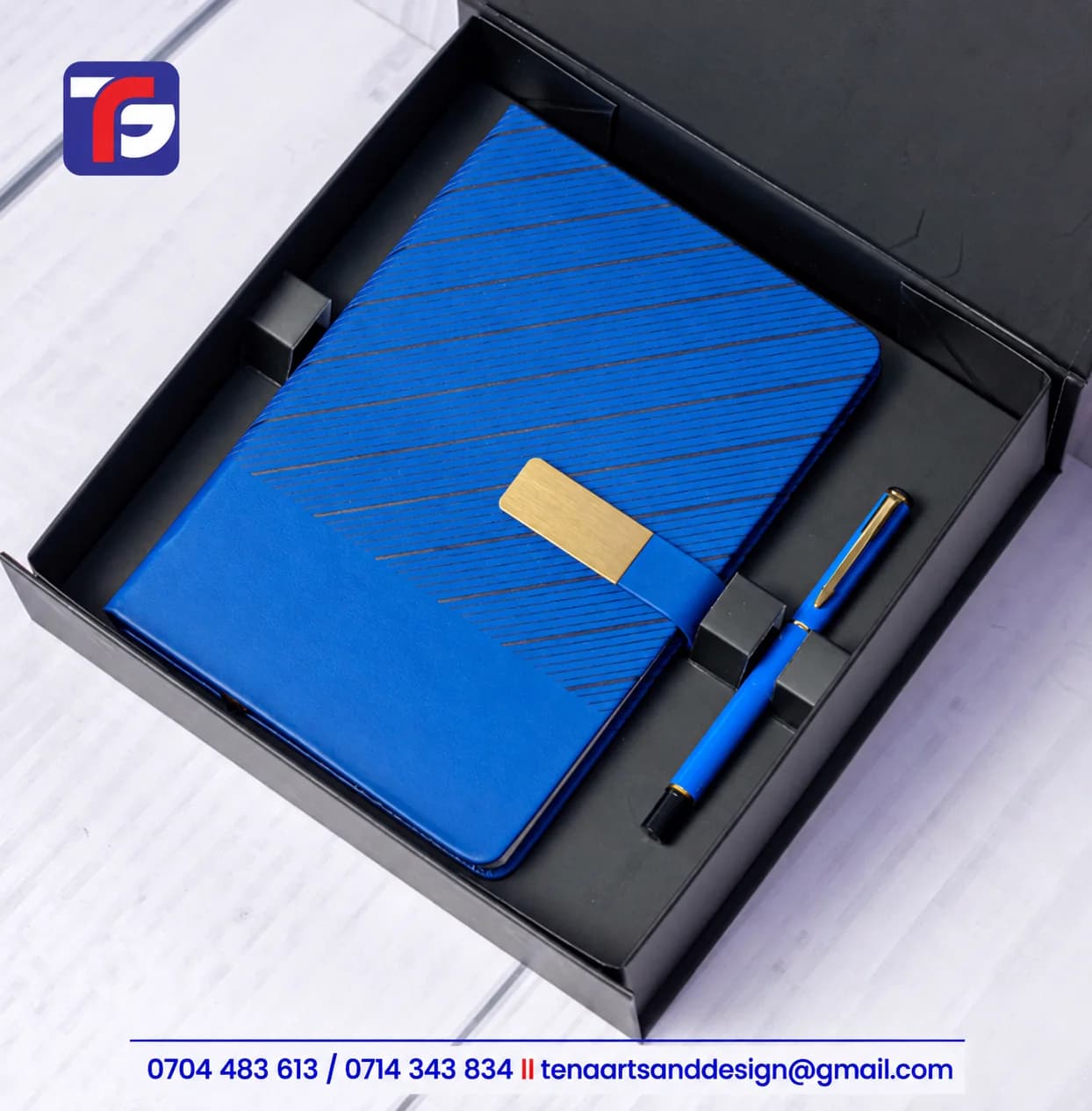 Blue Executive Wave notebook set with a patterned cover, gold-tone strap detail and matching pen in an open black presentation box