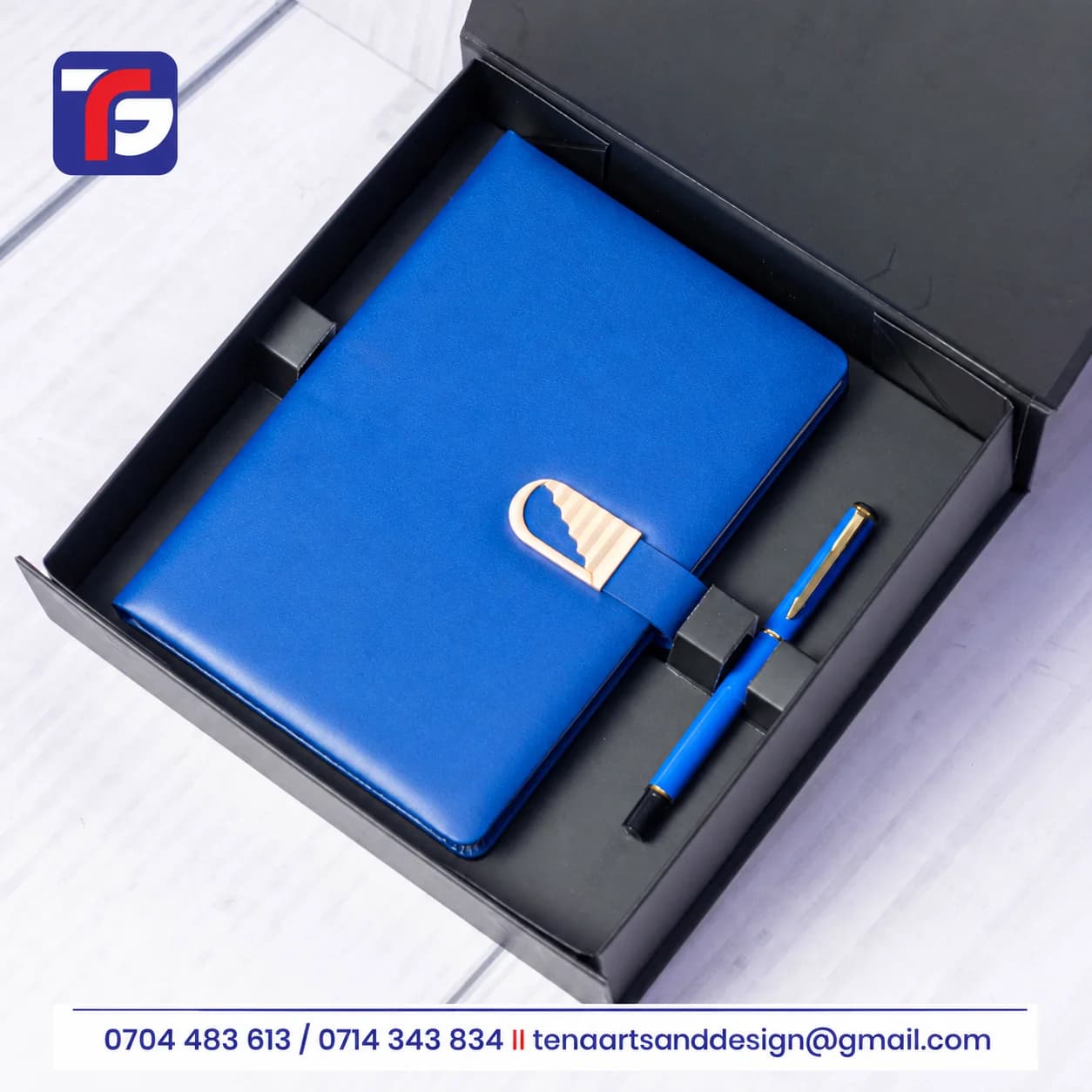 Blue Executive Goldbar notebook set with gold-tone strap detail and matching pen in an open black presentation box