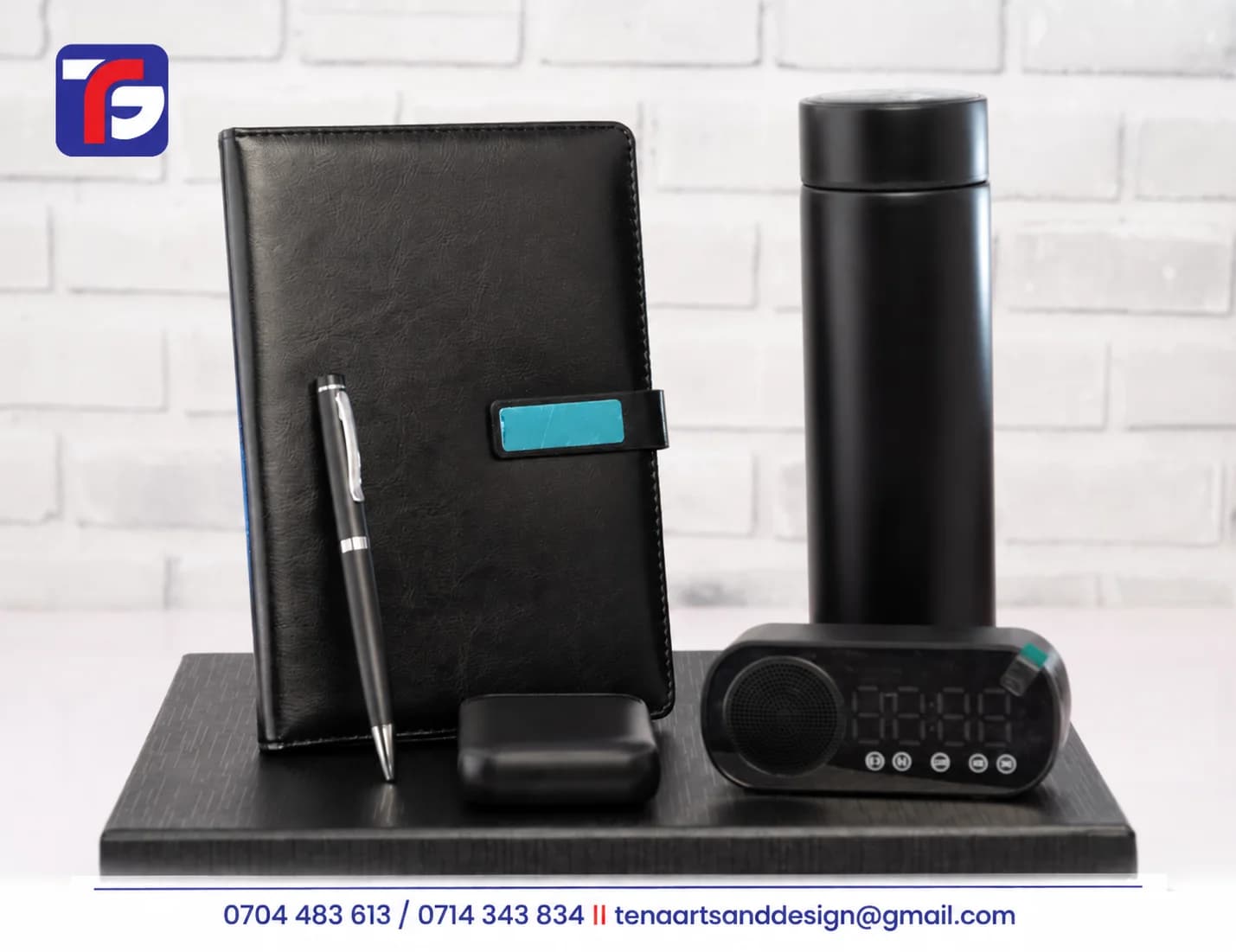 Black executive Bluetooth speaker gift set with notebook, pen, flask and compact power bank displayed on a presentation box
