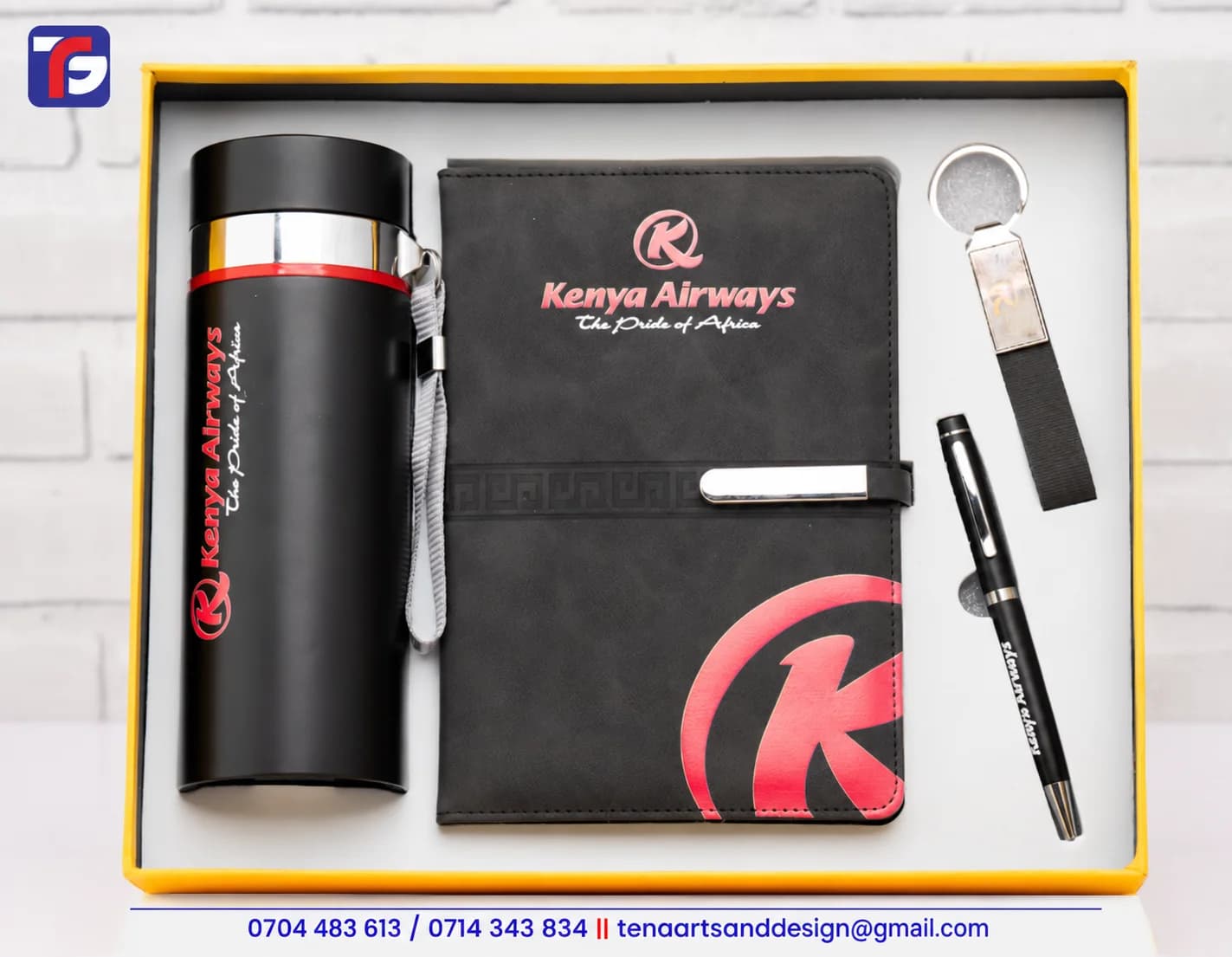 Black flask executive gift set with a notebook, pen and strap keyholder displaying Kenya Airways branding
