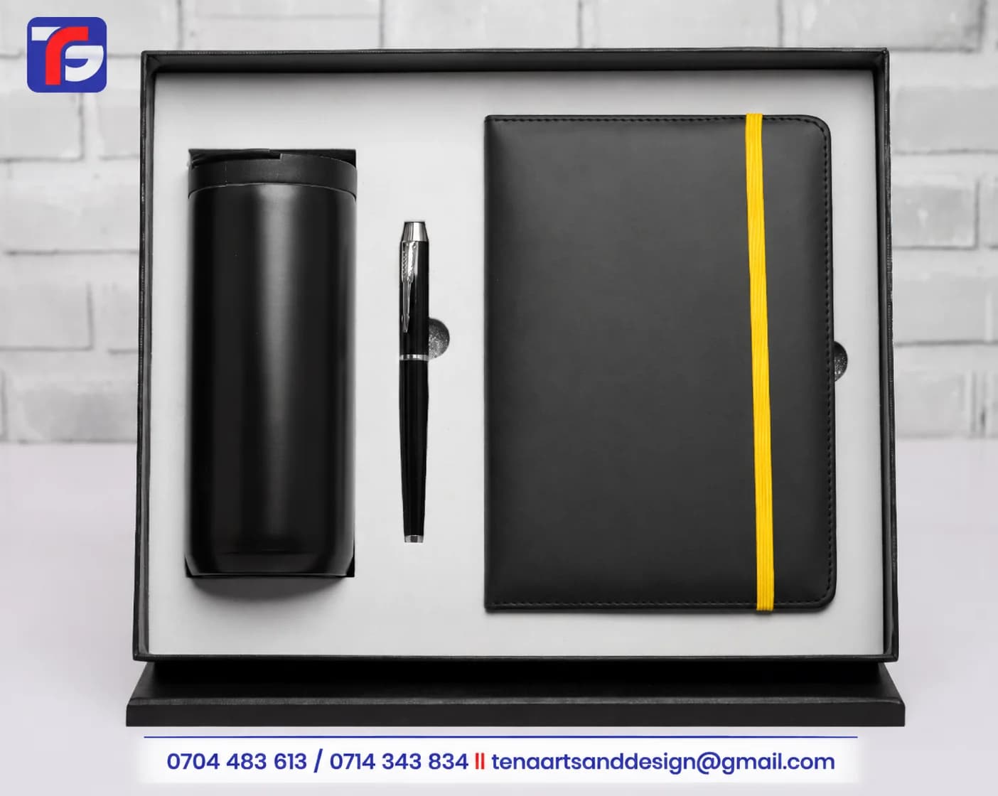 Black tumbler and notebook gift set with a pen and yellow notebook closure band in a presentation box