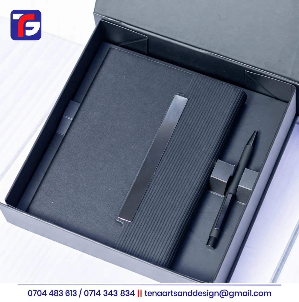 Black executive notebook pen set with a ribbed cover panel and metallic detail in an open presentation box