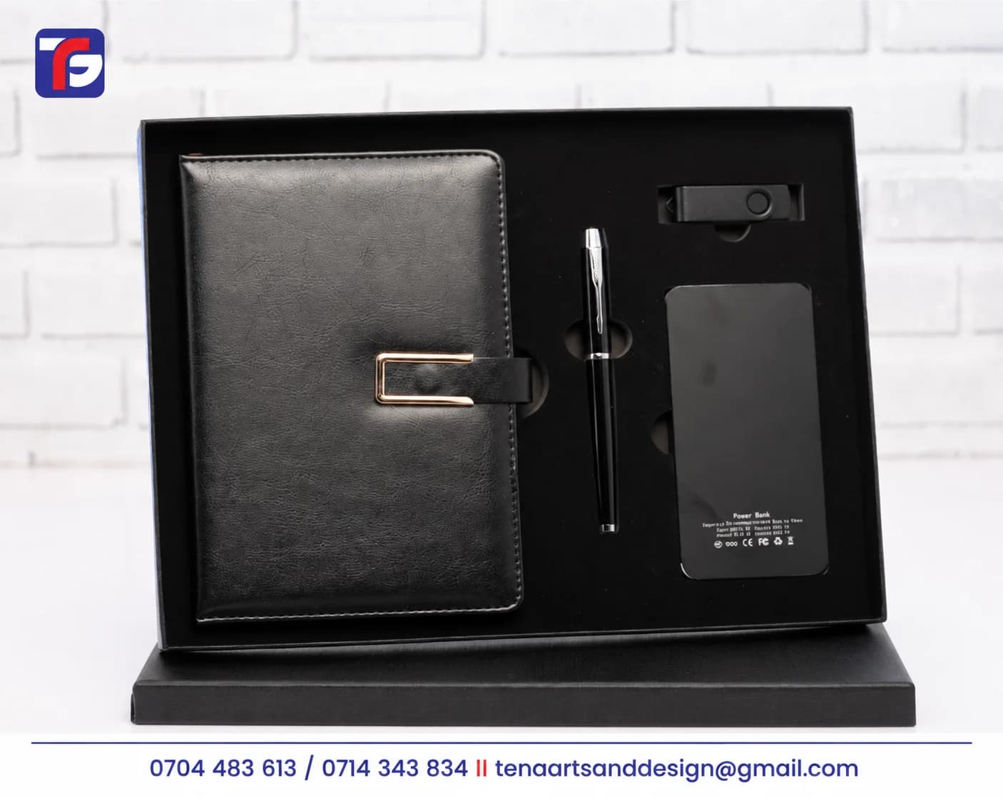 Black executive notebook tech gift set with a pen, power bank and swivel USB flash drive in an open presentation box