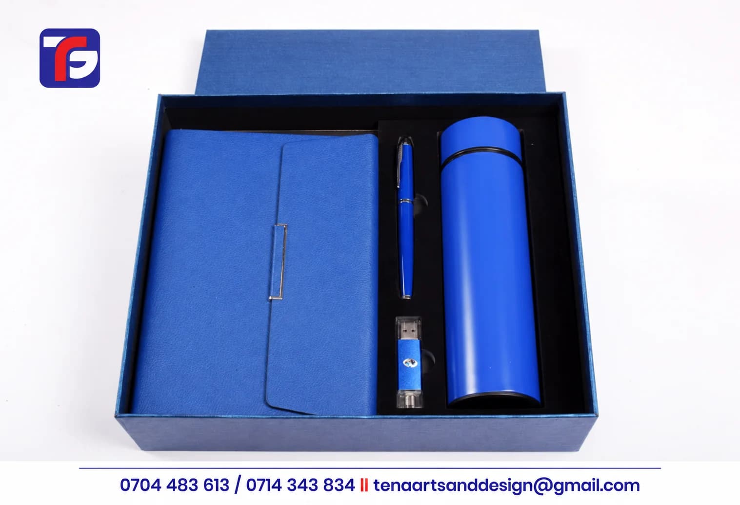 Blue executive notebook and flask gift set with a matching pen and USB flash drive in an open presentation box