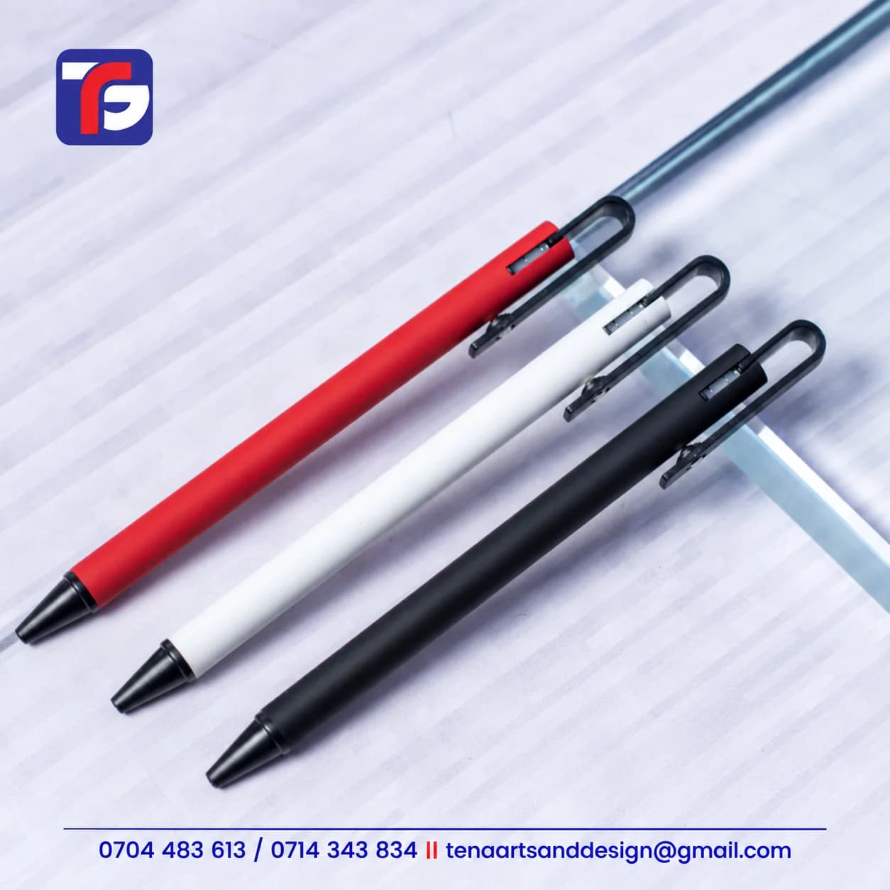 Loop clip executive pens in red, white and black with slim barrels, black tips and elongated black loop tops