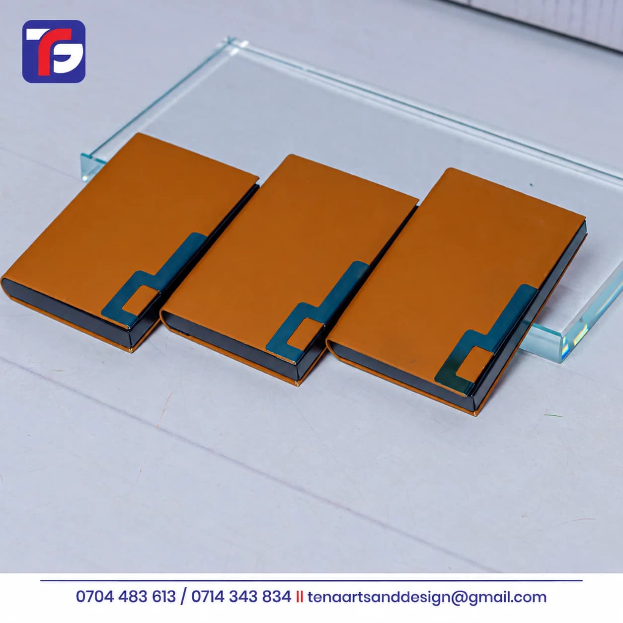 Three brown executive business card holders with dark edges and contrasting geometric cover details