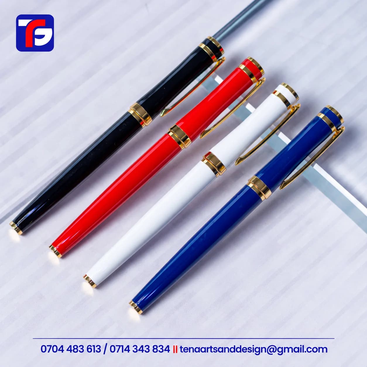 Gold trim luxury pens Kenya in black, red, white and blue with glossy bodies, gold-tone pocket clips and decorative bands
