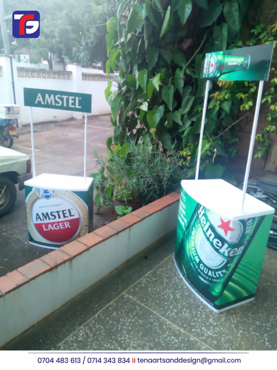 Two branded promotional kiosks with white countertops, printed front panels and overhead signs