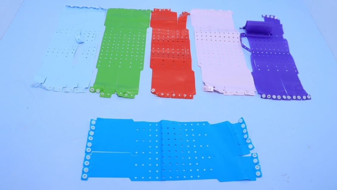 Assorted PVC hospital wristbands with adjustment holes and snap-style fasteners