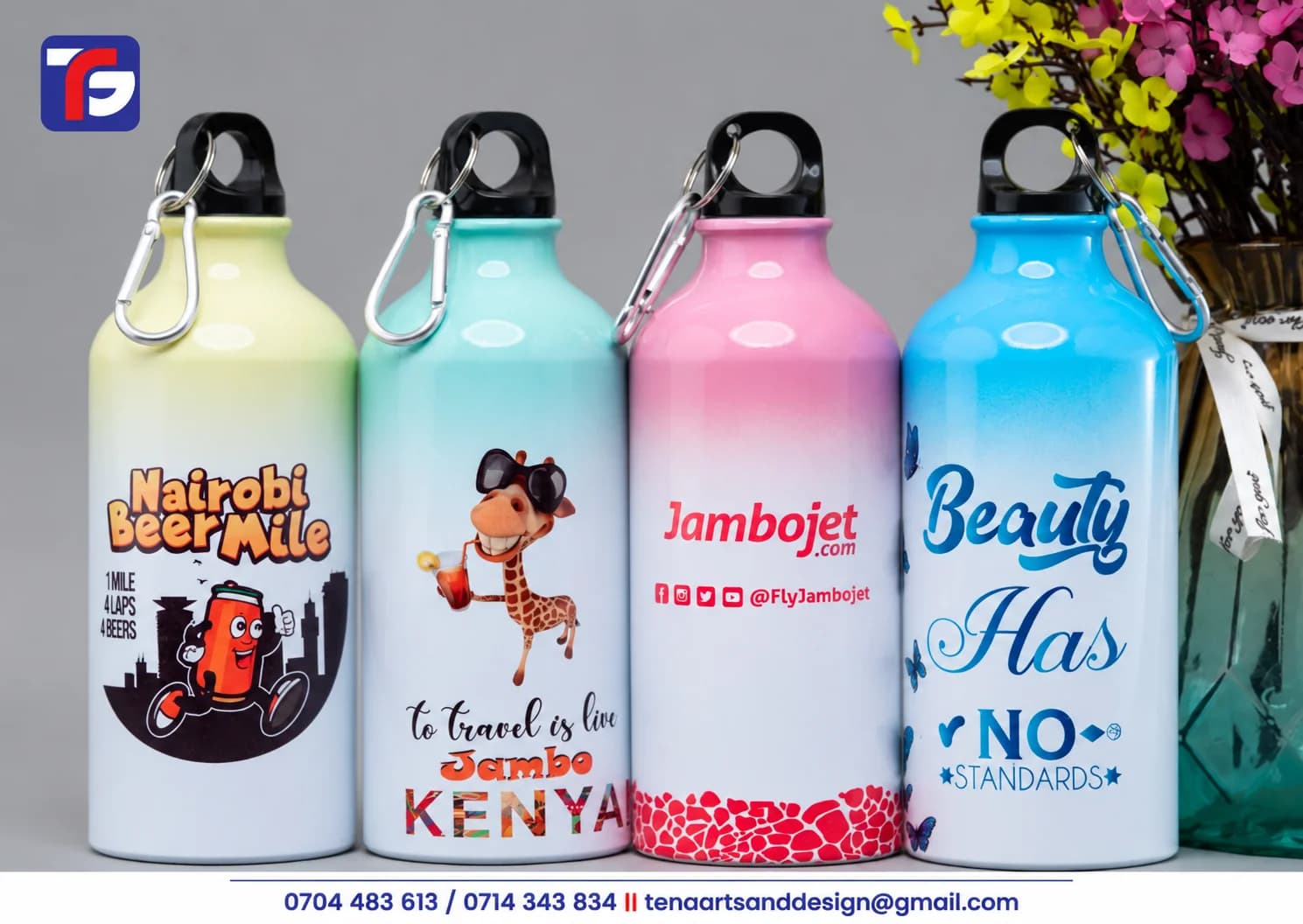 Four rainbow gradient water bottles in yellow, mint, pink and blue fading to white, with printed artwork, black caps and carabiner clips