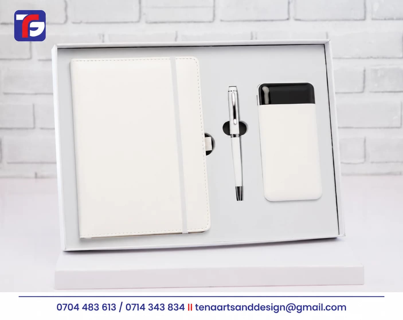 White notebook and power bank gift set with a matching pen arranged in an open white presentation box