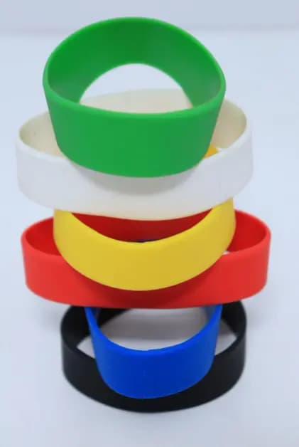 Wide adult loop wristbands stacked in green, white, yellow, red, blue and black